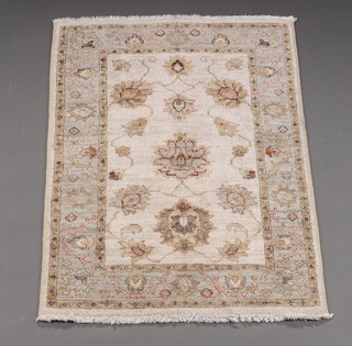 A white and green ground Ziegler floral patterned rug 100cm x 64cm 