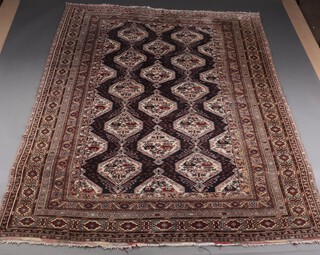 A black, white and brown ground Persian rug with 14 stylised medallions to the centre, with a multi row border 274cm x 197cm 