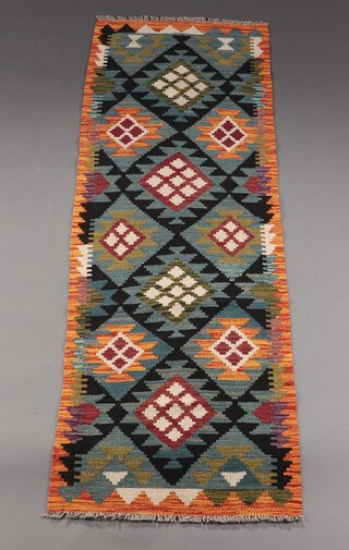 An orange, black and green ground Meshwani Kilim runner with all over geometric design 192cm x 62cm 