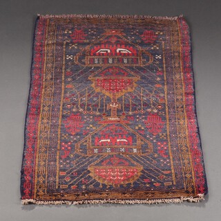 A red, blue and tan ground Belouche rug with floral design within a multi row border 122cm x 83cm 
