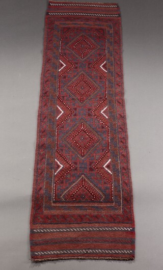 A red and blue ground Meshwani runner with 4 stylised diamonds to the centre 224cm x 61cm 