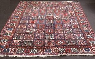 A large and impressive early 20th Century red, white and blue West-central Persian Bakhtiari carpet depicting a garden of paradise within 70 compartments and 3 row border, 407cm x 345cm 
